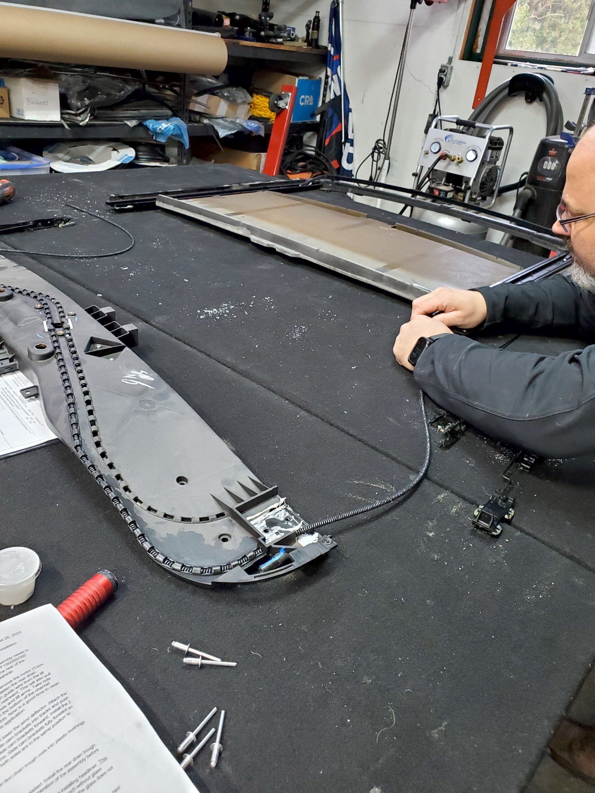 Threading the new sunroof tracks back in