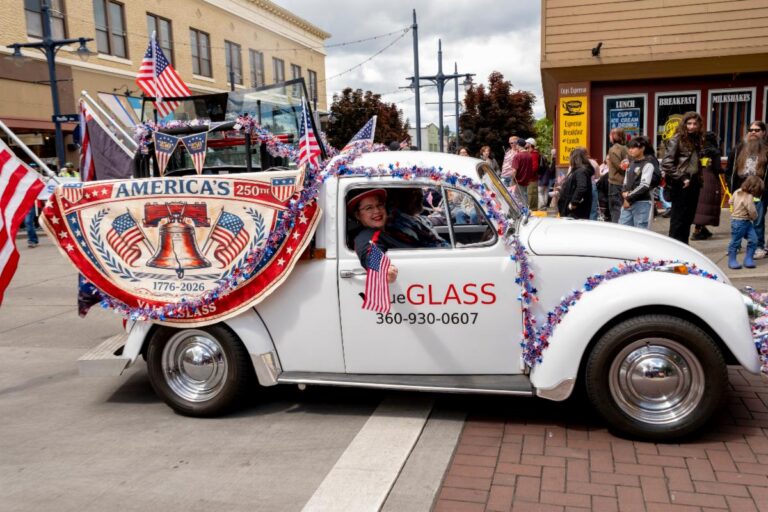 Buck in the Greater Kitsap Chamber June 2026 member spotlight valueGLASS’s Buck Volkswagen pickup decorated with American flags at a local parade