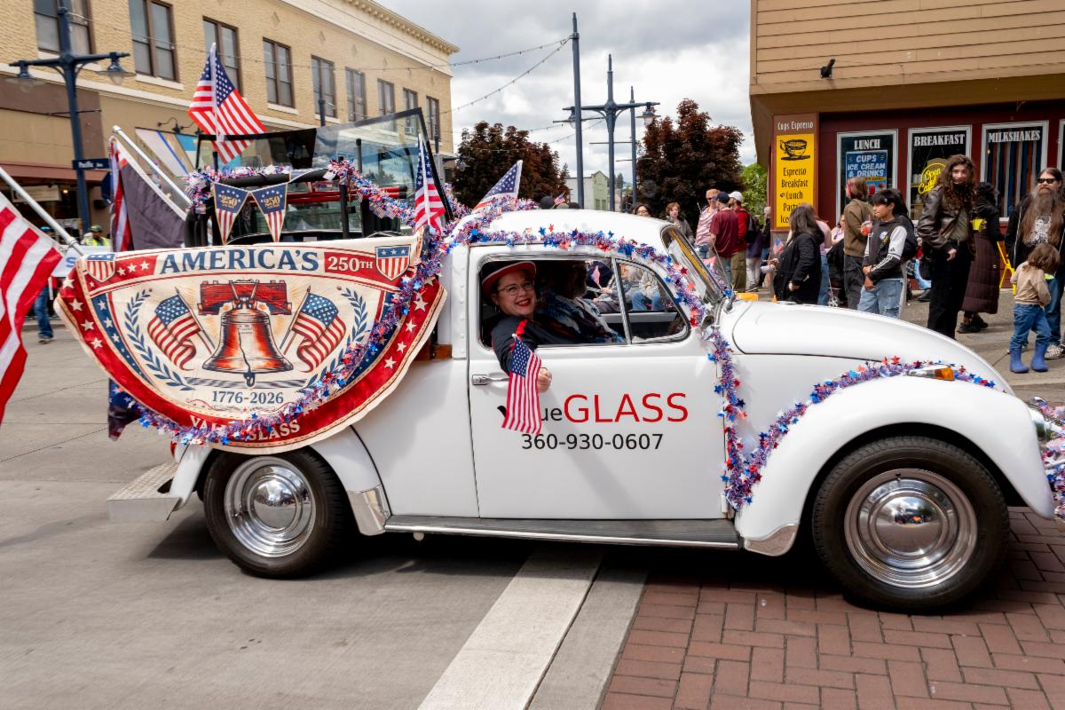Buck, the valueGLASS Volkswagen pickup, decorated with American flags at a local parade